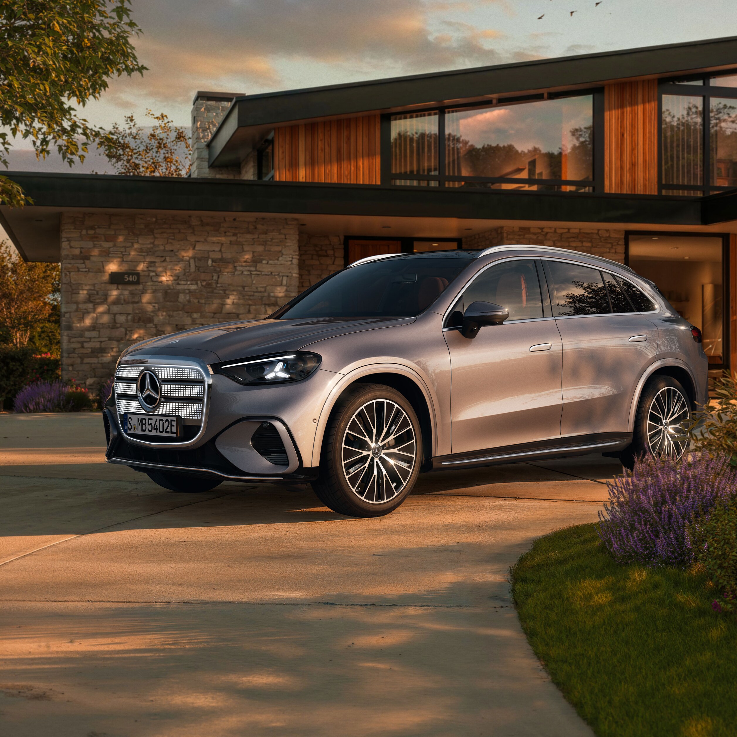 Visual aérea de un GLC plateado de Mercedes-Benz aparcado al frente de una casa