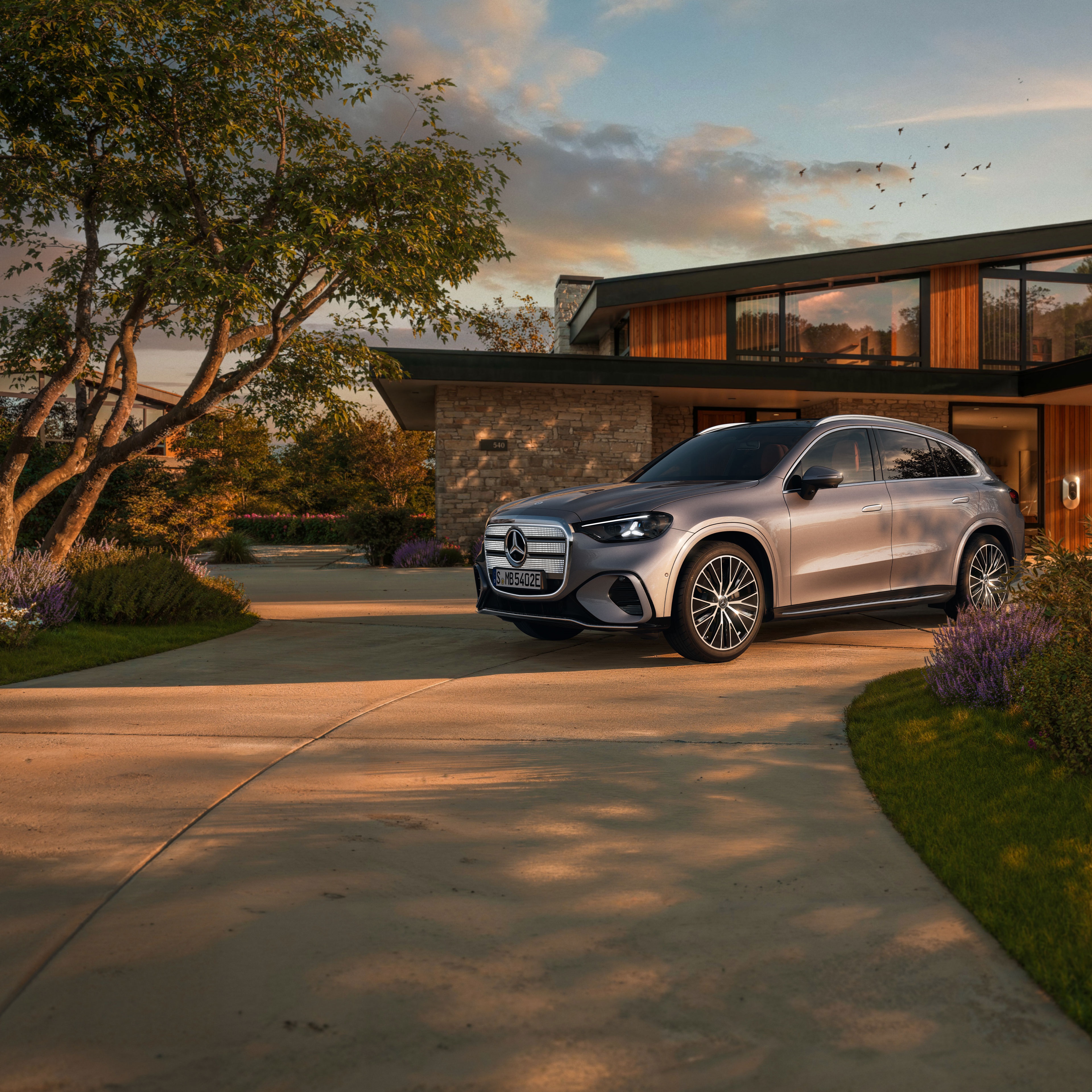 Visual aérea de un GLC plateado de Mercedes-Benz aparcado al frente de una casa