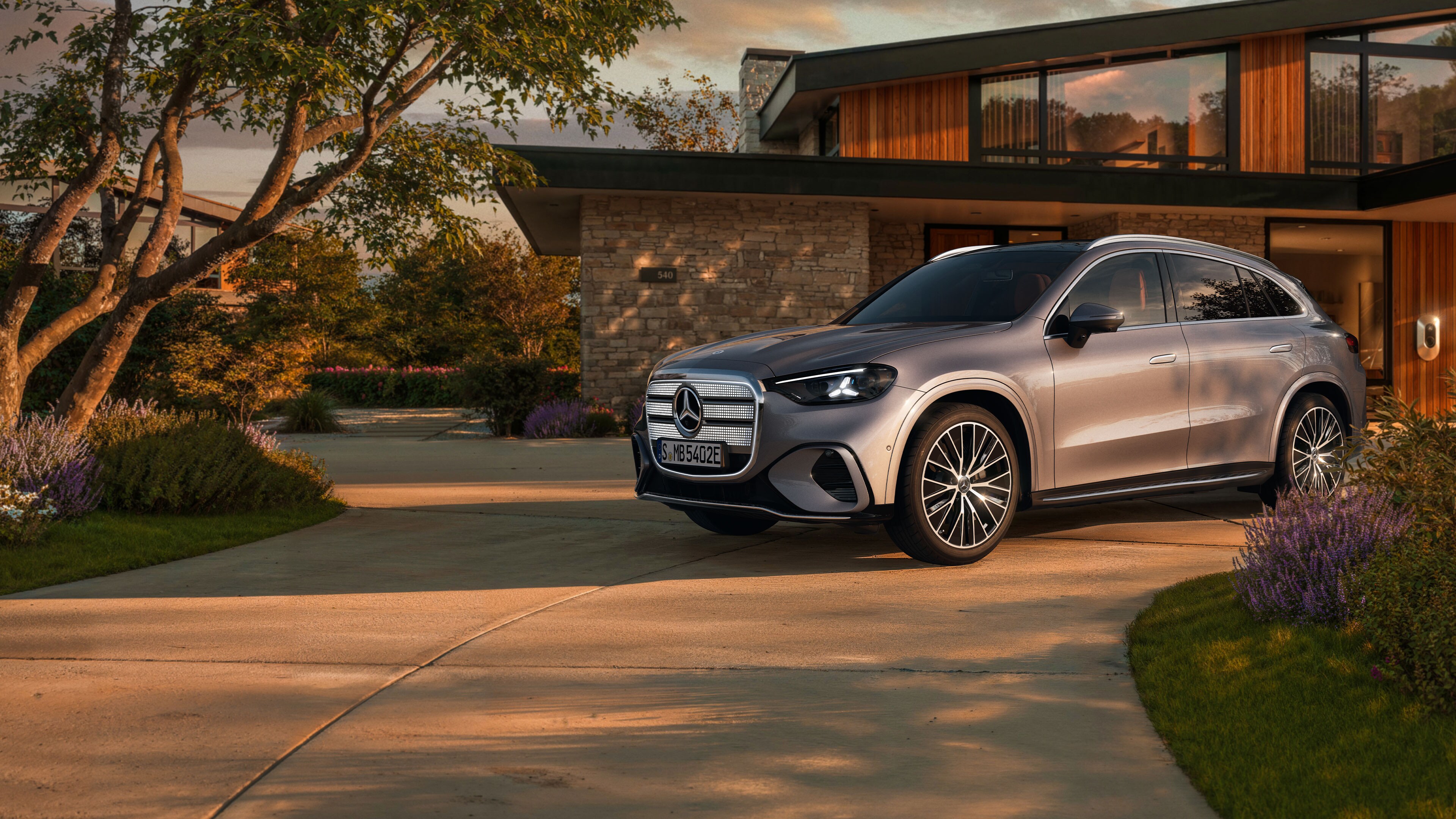 Visual lateral del GLC eléctrico en color gris frente a una casa