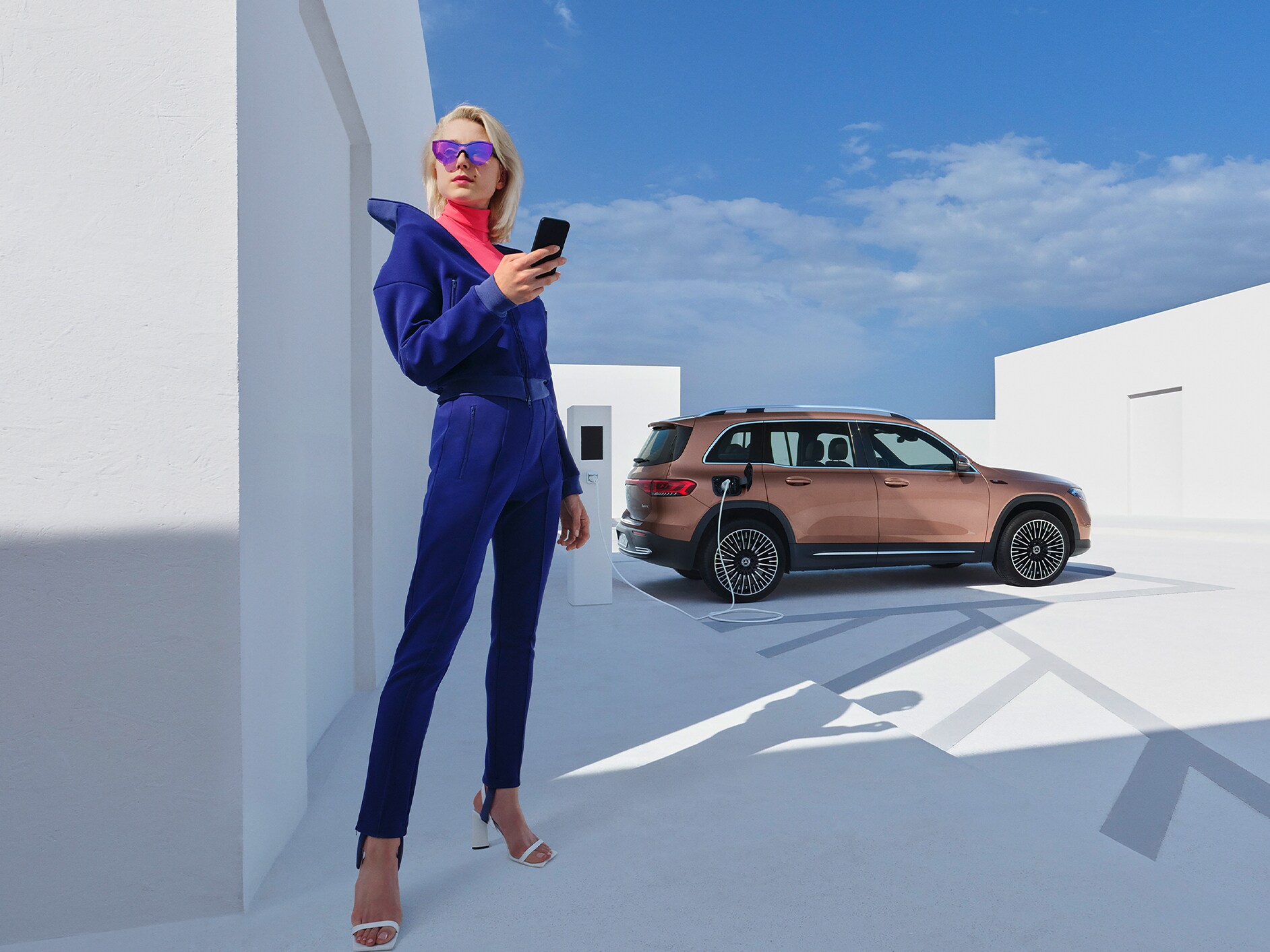 Una mujer carga cómodamente su Mercedes-Benz en una estación de carga de IONITY.
