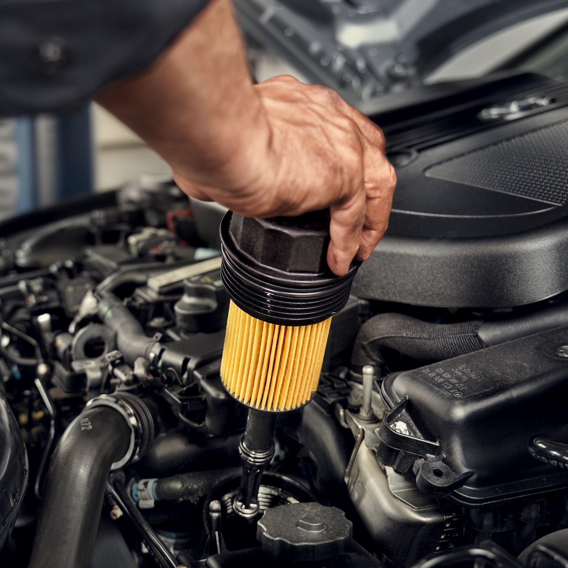 Oil filter | Mercedes-Benz A technician installing the oil filter to the Mercedes-Benz vehicle.