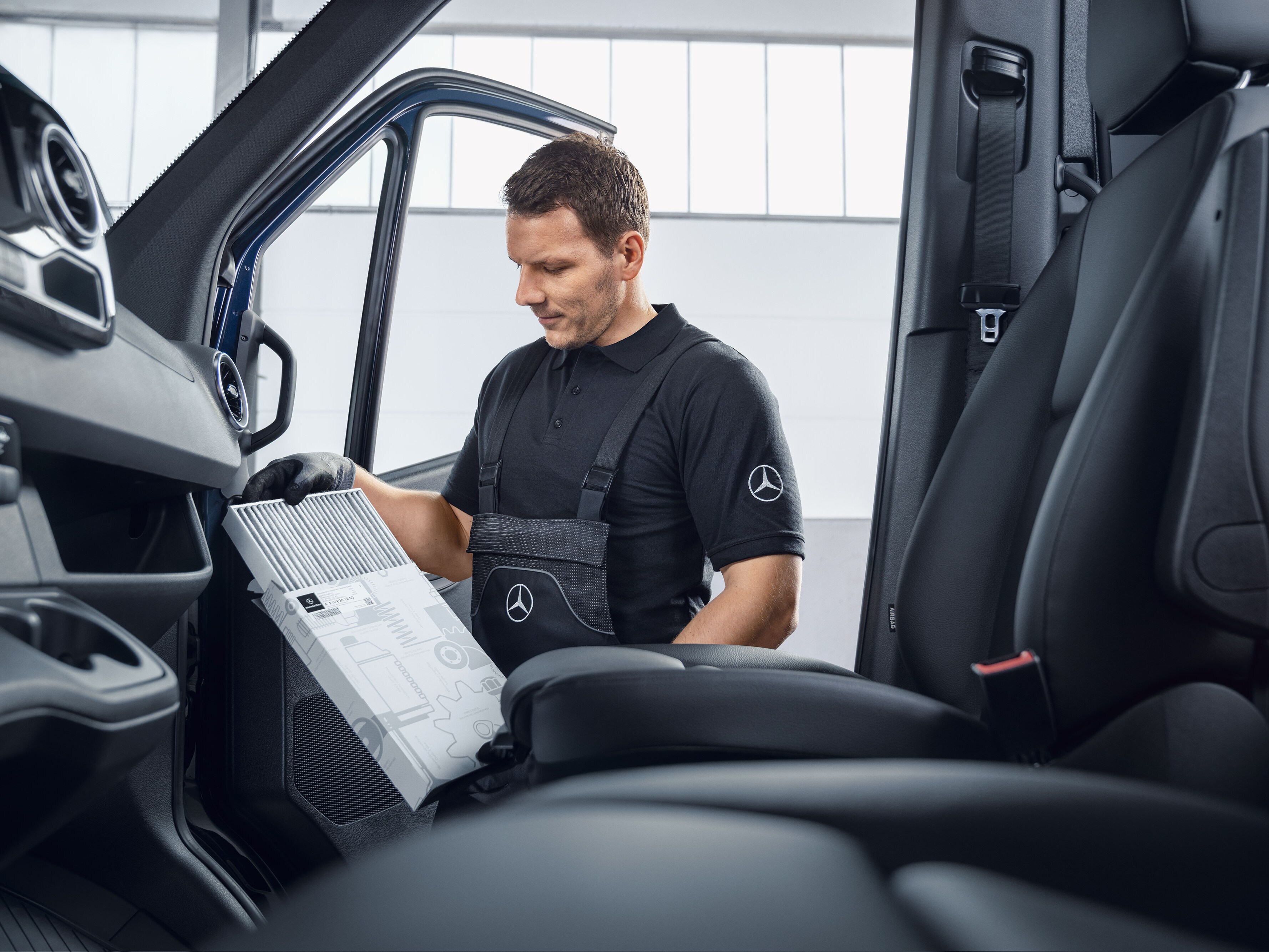 Un mecánico de Mercedes-Benz cambiando los filtros de aire.
