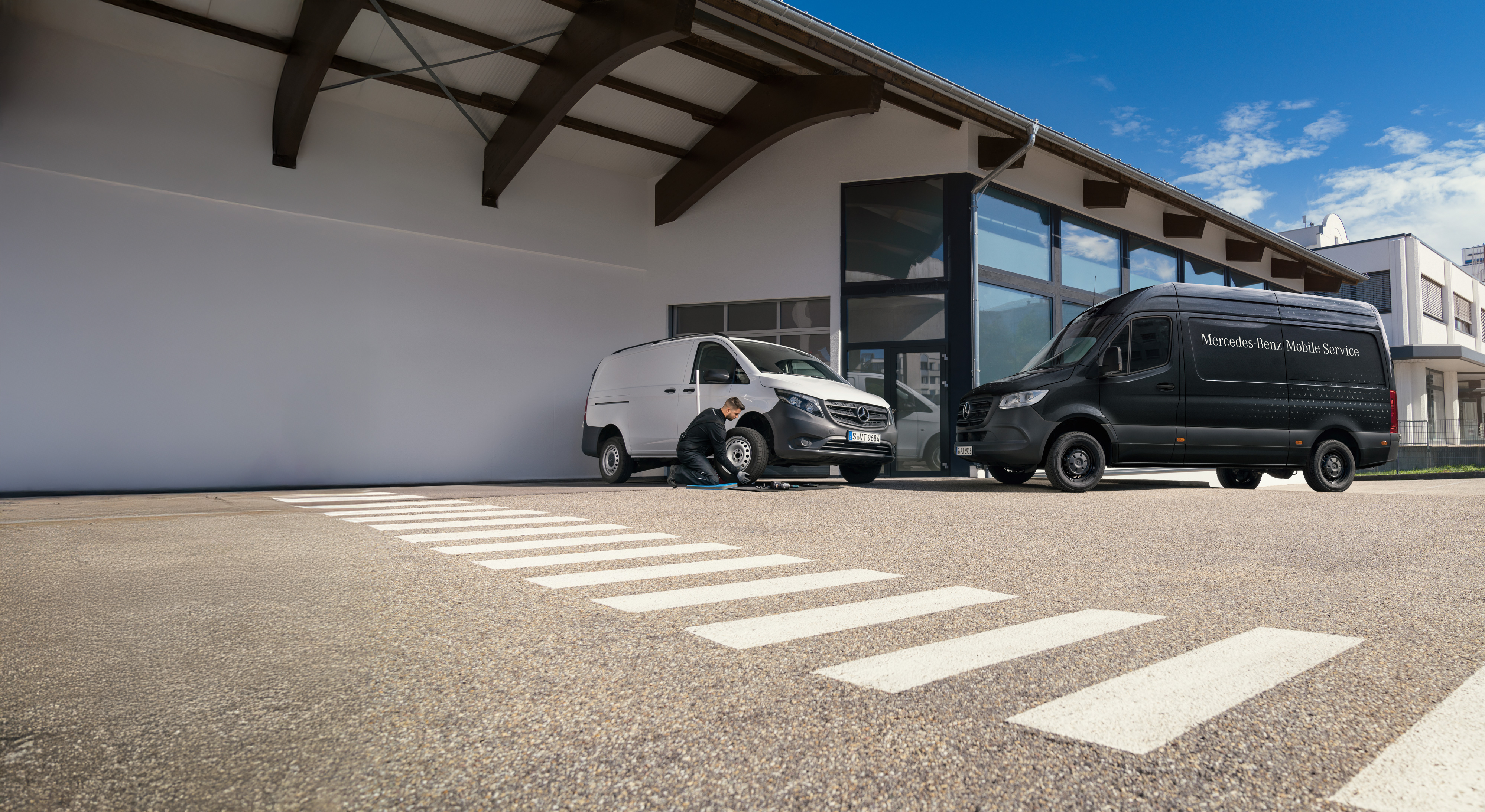 Mercedes-Benz | Mobile Service | Request a service A technician replaces a trye on a white Mercedes-Benz Vito vans in a carpark.