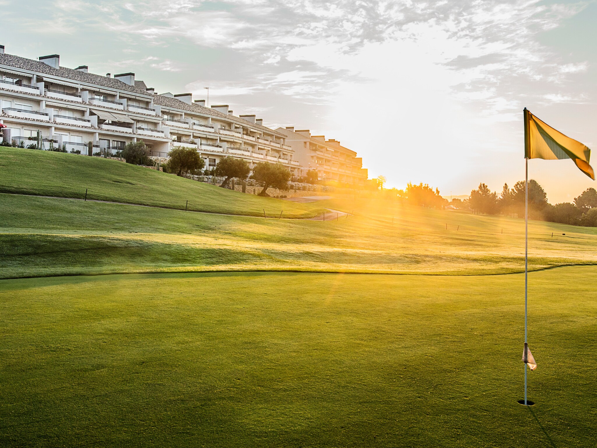 campo de golf con edificios al fondo