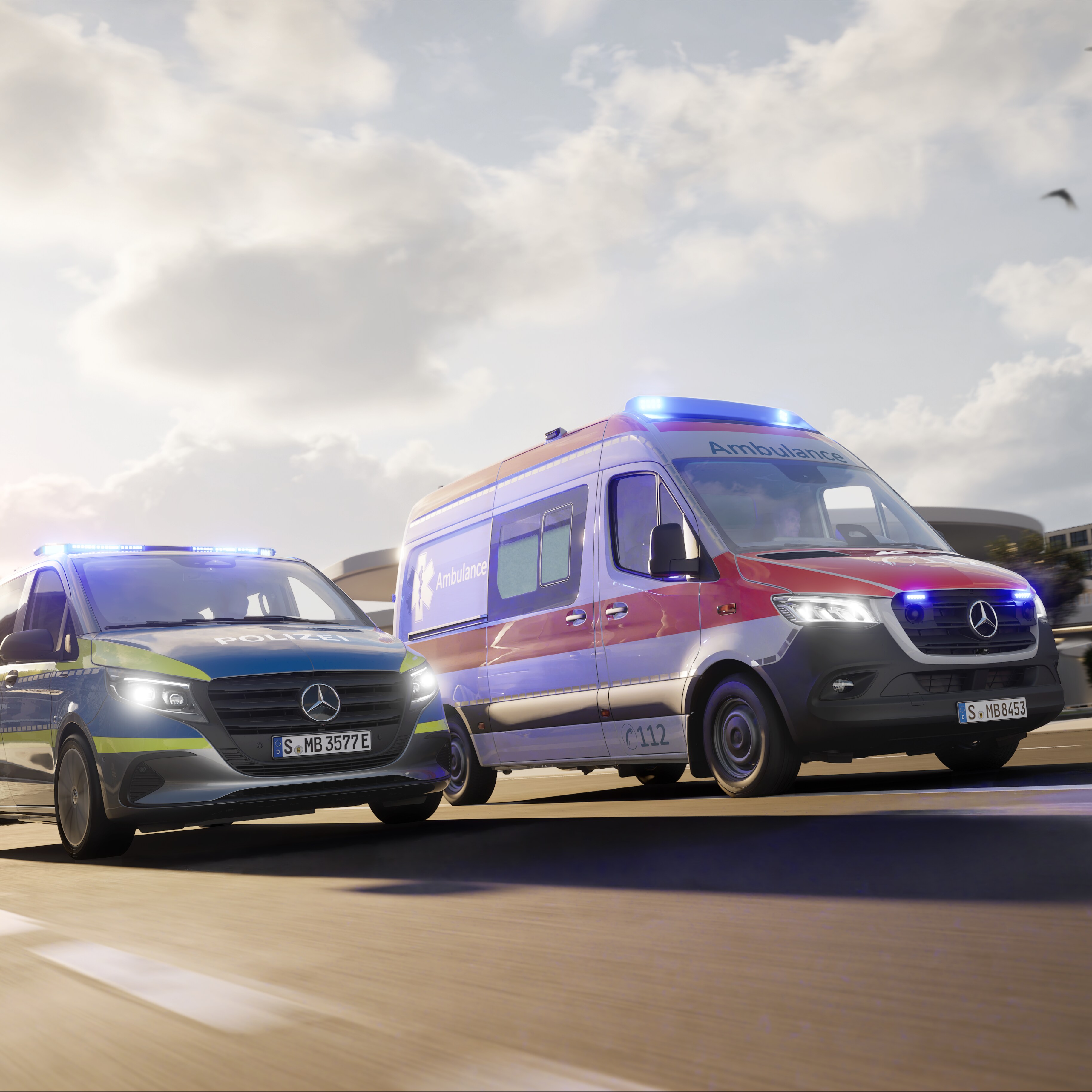 Dos vehículos especiales de Mercedes-Benz, una ambulancia basada en la Sprinter y un vehículo policial con luces azules activadas, circulan por un entorno urbano: soluciones fiables en vehículos para operaciones de rescate y emergencia.